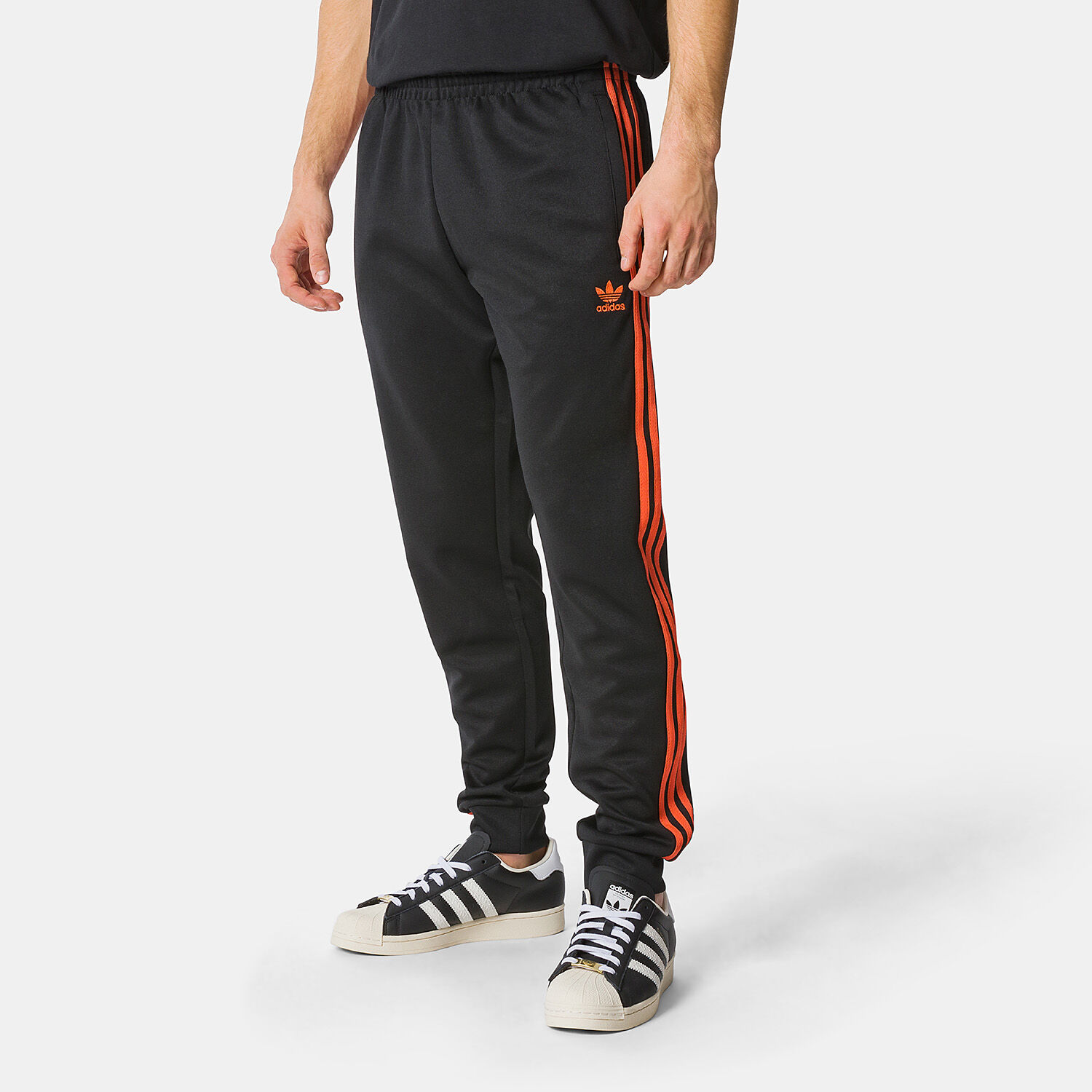 Black and orange adidas pants top